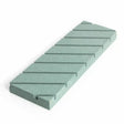 Rectangular green sharpening stone with diagonal grooves, used for woodworking tool honing.