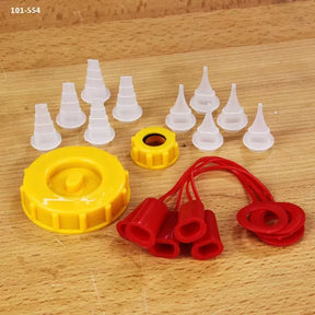 Glue bottle cap kit with yellow twist lids, red tip covers, and white glue nozzles on wood surface