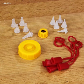 Wood glue applicator set with yellow caps, red covers, and plastic nozzles on wood surface
