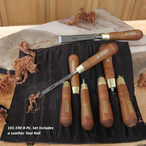8-piece woodworking chisel set with wooden handles and leather tool roll on workbench