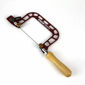 Precision woodworking coping saw with red open frame and wooden handle on white background