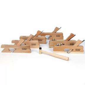 Set of wooden hand planes with brass mallet for woodworking on white background