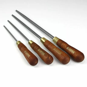 Set of four woodworking rasps with wooden handles for precision wood shaping
