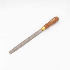Hand woodworking rasp with textured steel blade and wooden handle on white background