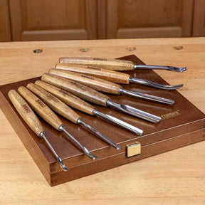 Wood carving chisel set with wooden handles on a wooden case, ideal for woodworking projects