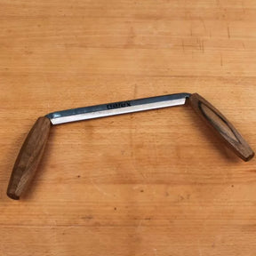 Narex drawknife with wooden handles on a woodworking bench