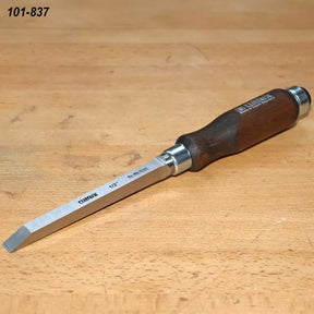 1/2 inch mortise chisel with steel blade and wooden handle on workbench
