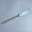 Japanese pull saw with fine teeth and ribbed beige handle on white background