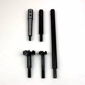 Five-piece woodworking drill bit and adapter set on white background