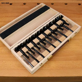 Woodworking Forstner drill bit set in wooden case on a workbench