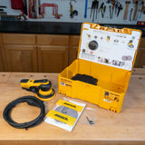 Sander with open yellow case and Mirka accessories on a wooden table