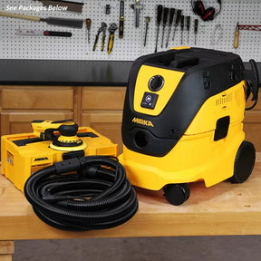 Mirka dust extractor vacuum and orbital sander set with hose on a woodworking bench