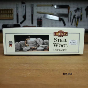 Liberon ultrafine steel wool 0000 box on workbench in woodworking shop