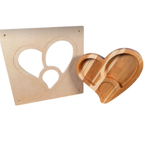 Heart-shaped woodworking router template with finished wood tray on white background