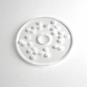 Clear plastic router table insert ring with raised spiral grips on white background