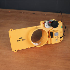 Yellow PRO blast gate for dust collection, with electronic switch on wood surface