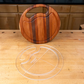 Clear acrylic cutting board template and wooden cutting board on a workbench