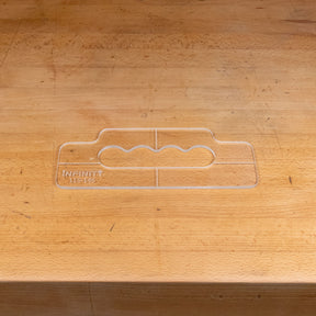 Clear acrylic handle template for woodworking on a wooden workbench