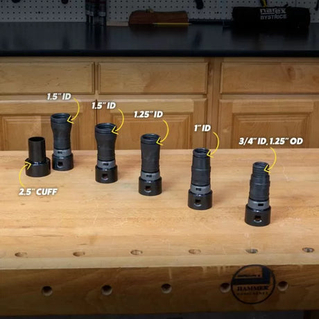 Set of six black woodworking dust hose adapters with labeled diameters on a workbench.