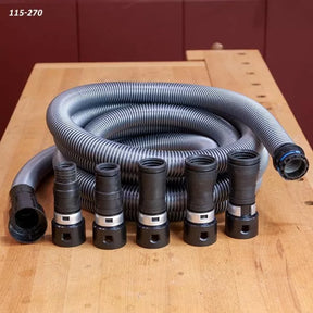 Flexible dust collection hose with five woodworking adapter fittings on a wooden workbench