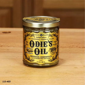 Odie's Oil universal wood finish and polish jar on a wooden surface