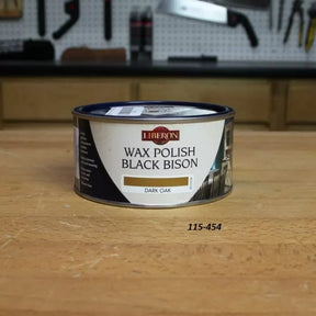 Liberon Black Bison dark oak wax polish tin on a woodworking bench