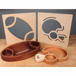 Woodworking templates and finished trays in football and helmet shapes on a workbench