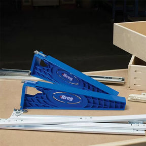 Drawer slide jigs for woodworking, blue plastic guides with metal rails on workbench