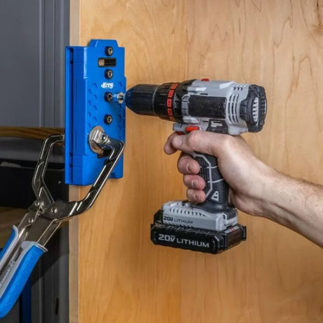 Drill and Kreg pocket hole jig clamped to wood for precise woodworking joinery