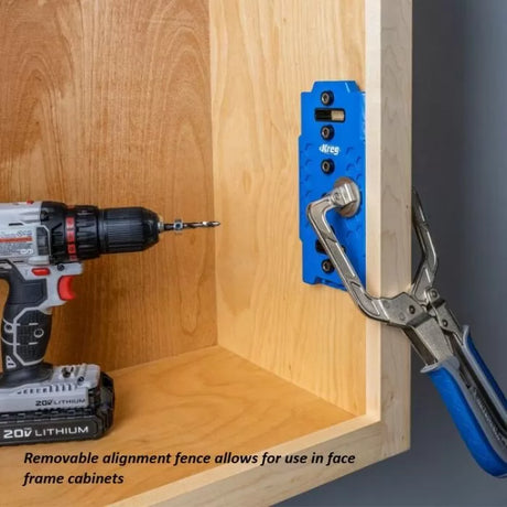 Cordless drill and Kreg pocket hole jig clamped to wooden cabinet for woodworking joinery