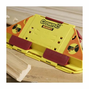 Crown45 yellow and red crown molding jig for woodworking on a table with trim piece