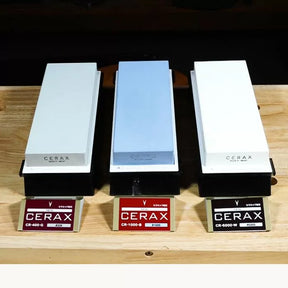 Three CERAX sharpening stones in different grits on wooden surface for woodworking tools