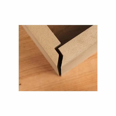 Box jointed MDF corner with clean woodworking cut on a wooden workbench