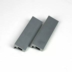 Pair of gray segmented push blocks for woodworking safety on white background