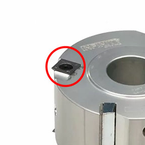 Carbide woodworking cutter head with insert highlighted, used for precision joinery