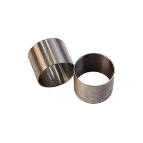 Pair of metal bushings for woodworking machinery on white background