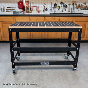 Black workbench with dog holes in a workshop setting