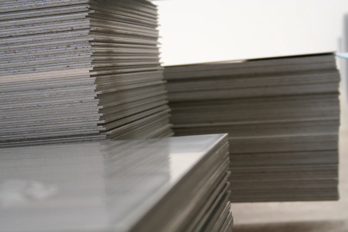 Stacks of metal sheets on a light background