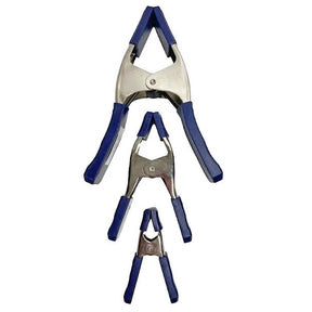 Set of three metal spring clamps with blue handles for woodworking projects
