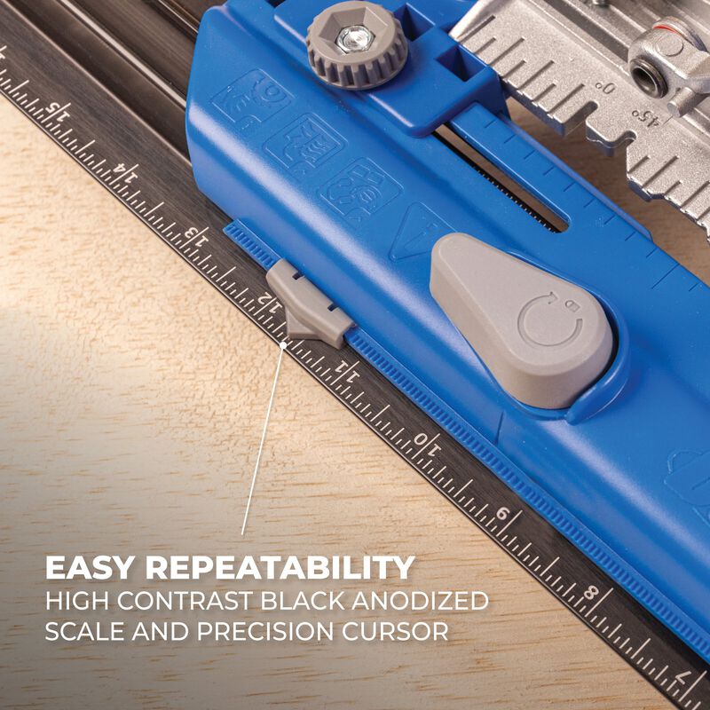 Blue measuring tool with a high contrast black anodized scale on a wooden surface