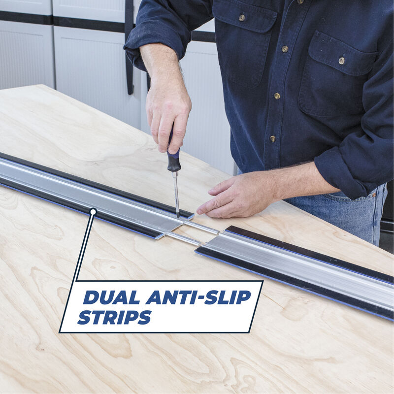 Person installing dual anti-slip strips on a wooden surface with a tool.