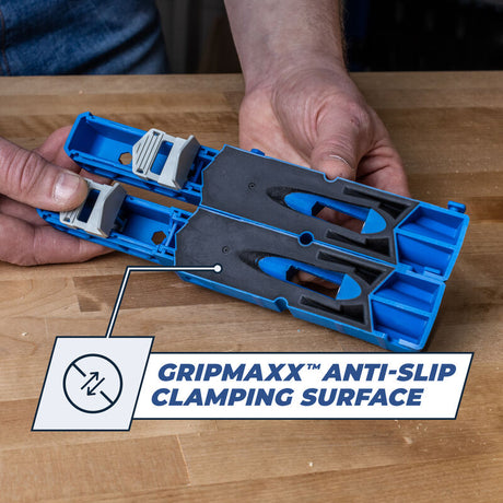 Hands holding a blue woodworking jig with GripMaxx anti-slip clamping surface on workbench