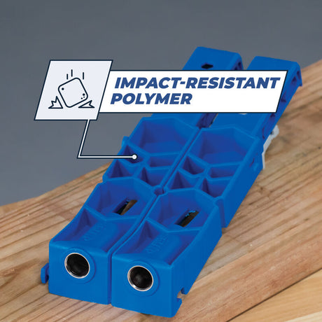 Blue impact-resistant polymer pocket hole jig on wooden board for woodworking