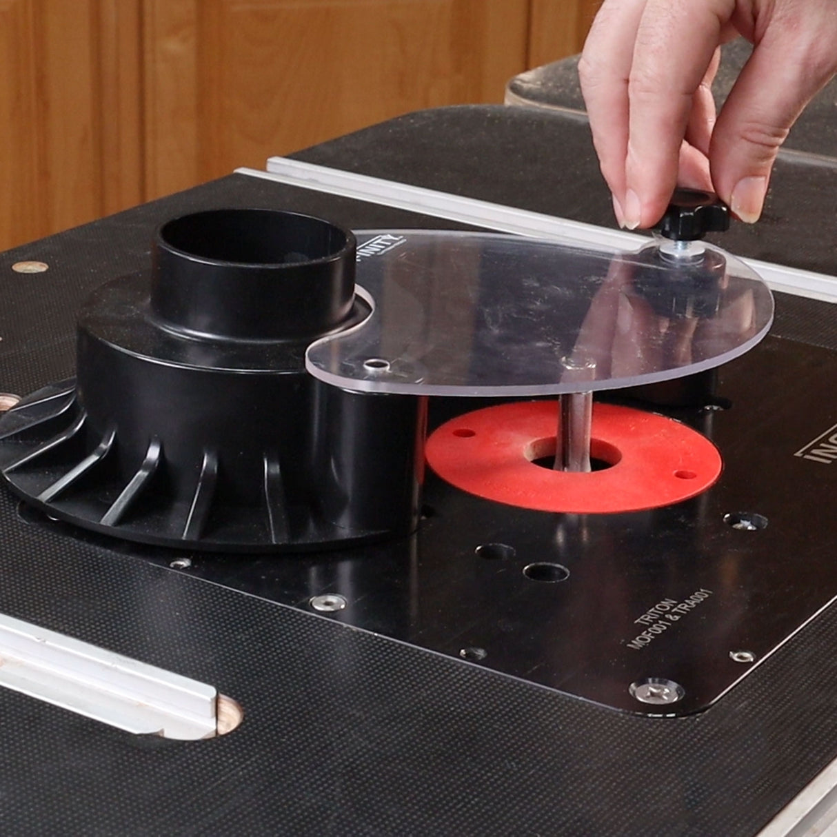 Attaching the nuatilus dust guard to a router table.
