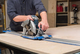 Person using a circular saw on a workbench with a workshop background