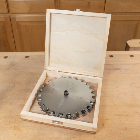 Wooden box with a circular saw blade inside on a wooden surface