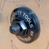 A close-up of the Infinity Tools SuperNut mounted on a table saw blade arbor.