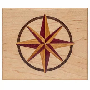 Wood inlay compass rose star design on light maple panel, ideal for woodworking projects