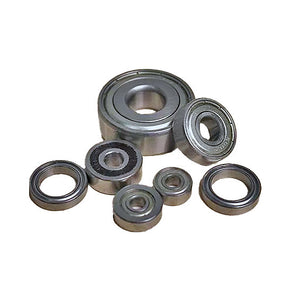 Assorted metal ball bearings for woodworking tools on white background