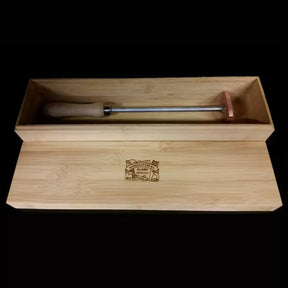 Woodworking branding iron with wooden handle in engraved wooden gift box on black background
